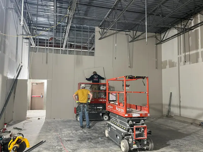 Metal stud framing and a scissor lift on a retail build-out