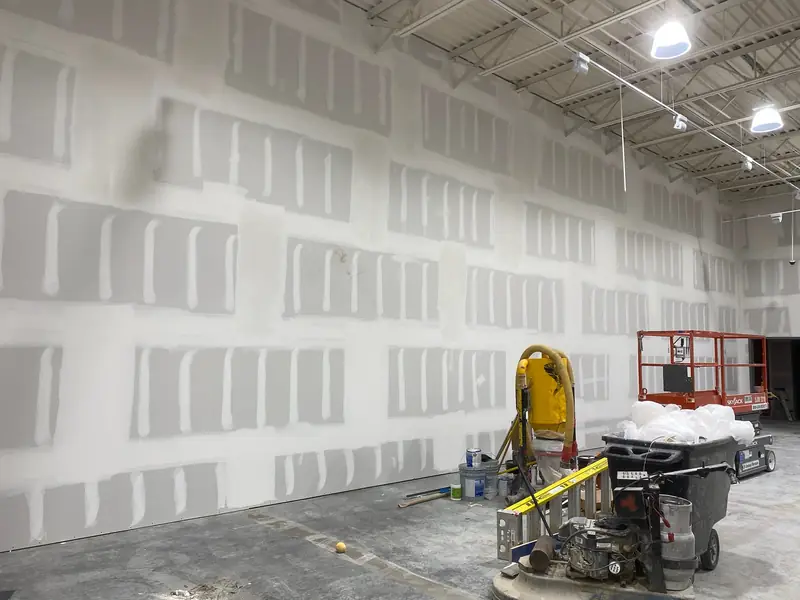 Taped drywall on a tall retail wall